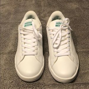 White and green Adidas sneakers